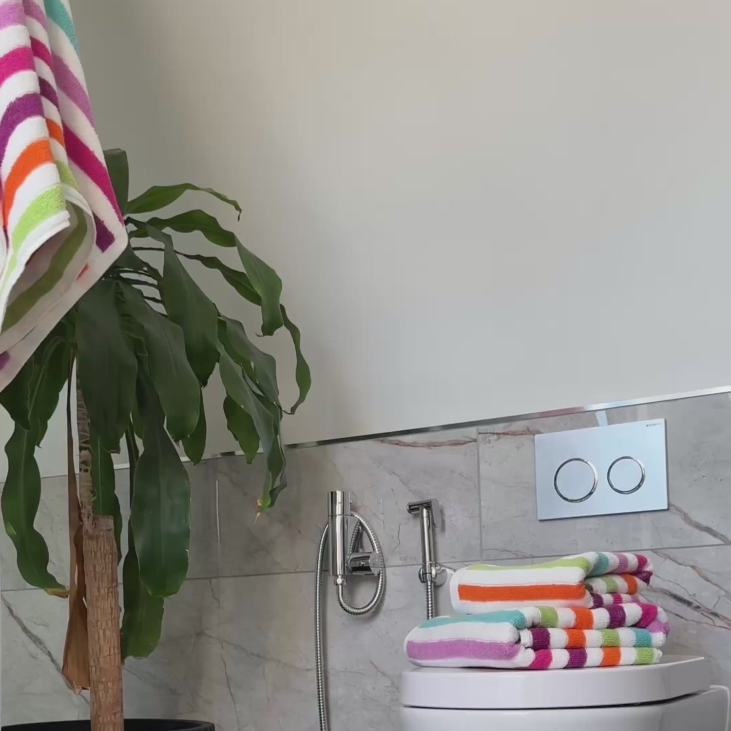 Blue, green and pink towels in a striped pattern.