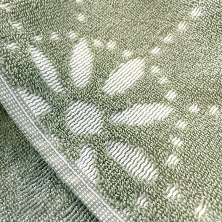 Sculpted patterned floral towels in sage green.