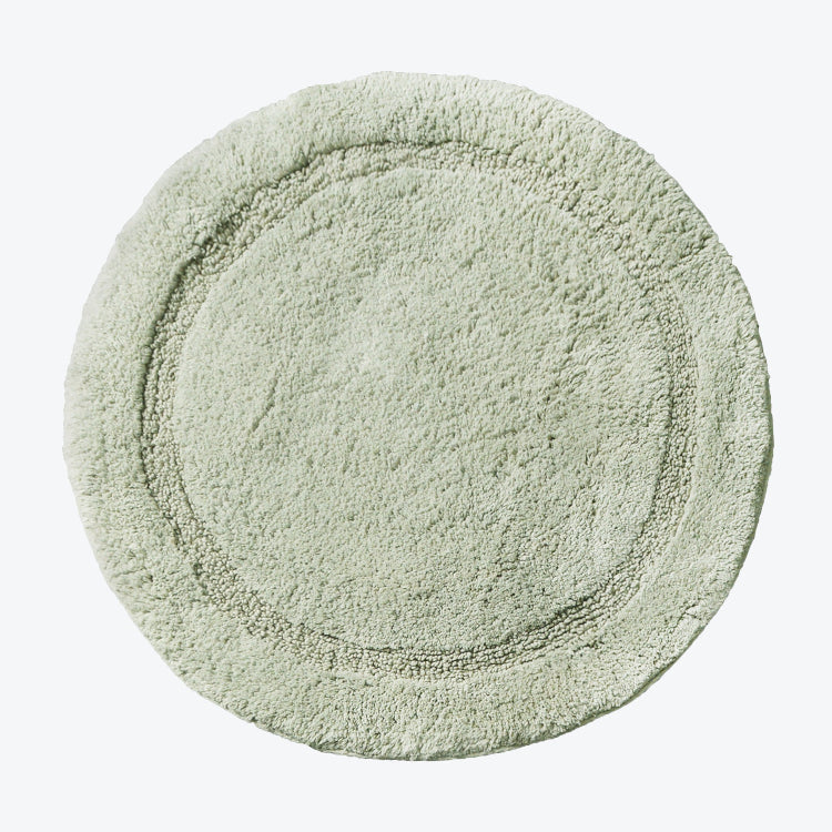 Sage green round cotton bath mat, non slip backing.