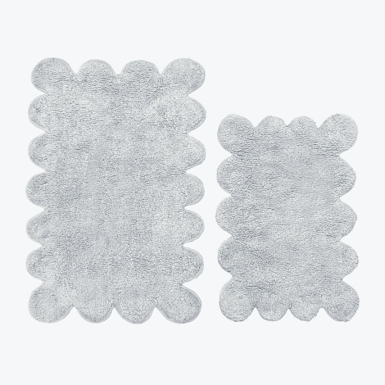 Grey bath mat set in scalloped design, made from 100% cotton.