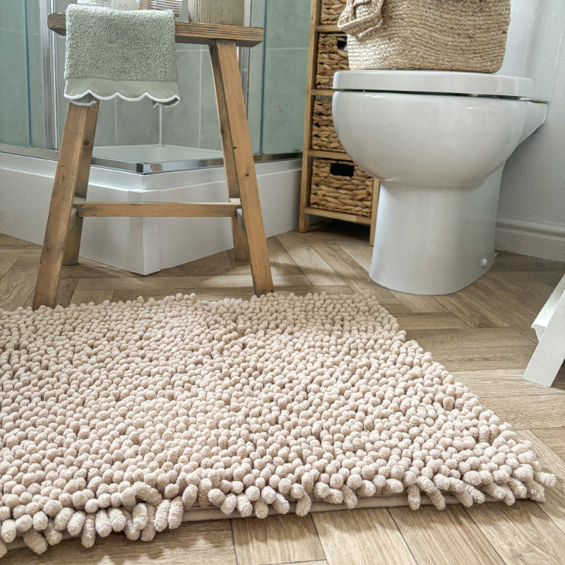 Beige thick bobble bath mats.