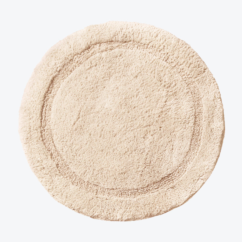 Beige circular bath mat, super soft and absorbent - made from cotton.
