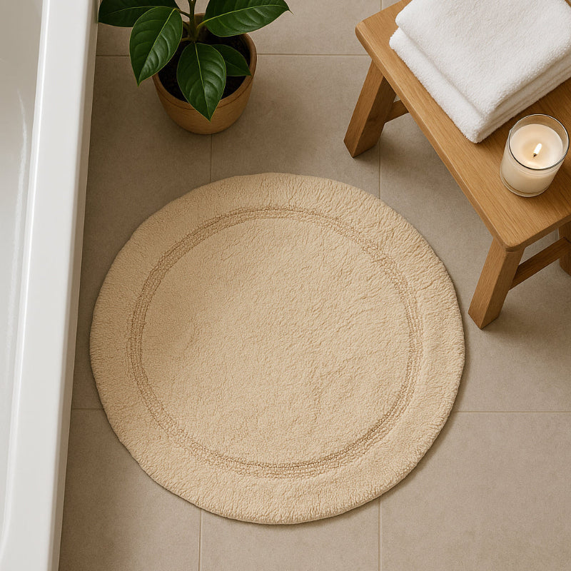 Beige/stone round cotton bath mat.