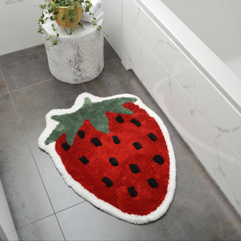 Fun fruit bath mat, with red strawberry shape. Statement rug for the living room or bedroom.