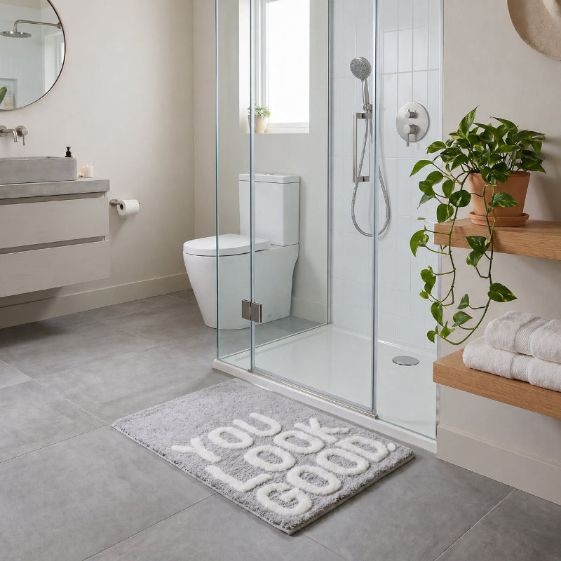 Grey bath mat with you look good slogan.