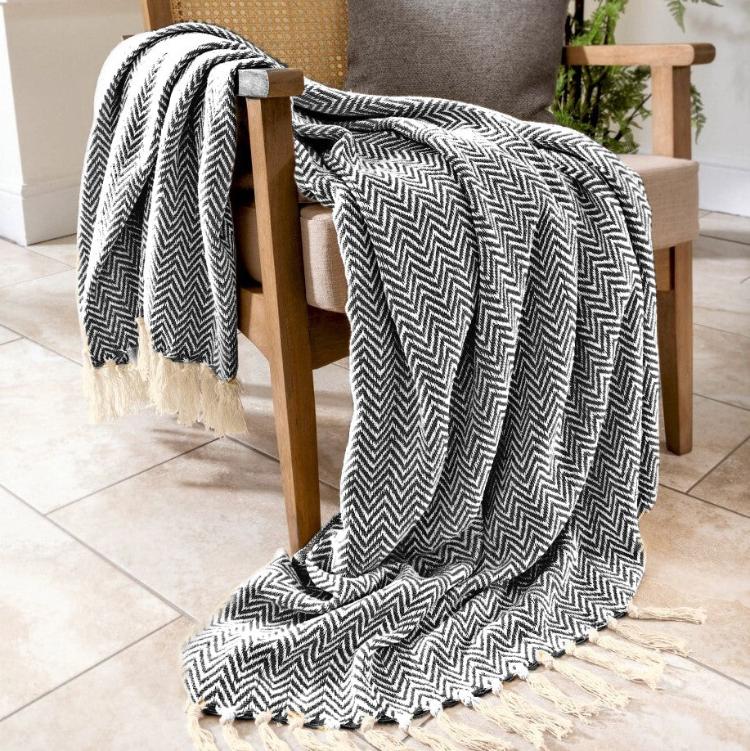 Audley herringbone chevron throw in charcoal with tassels.