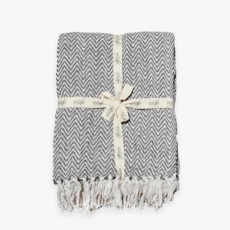 Grey herringbone throw, ribbon tied blanket.
