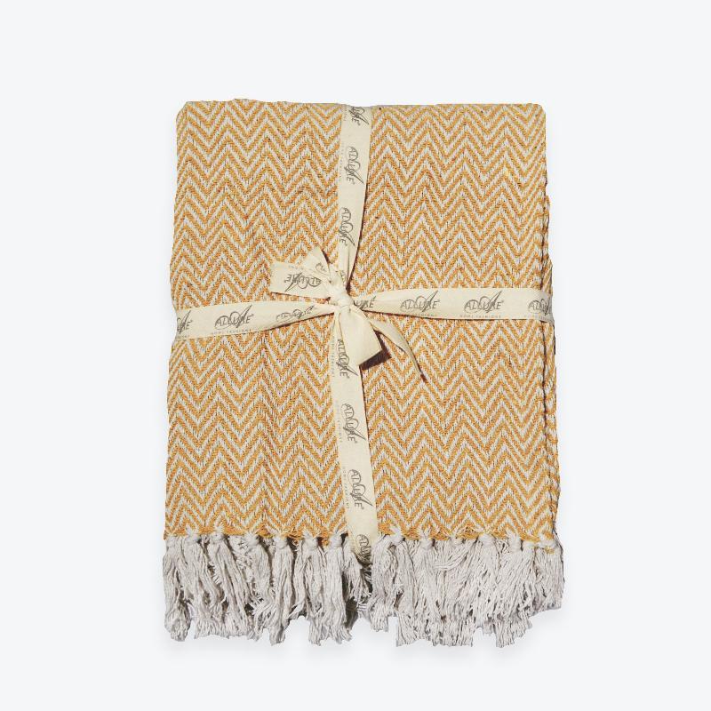 Mustard herringbone throw, ribbon tied gift.