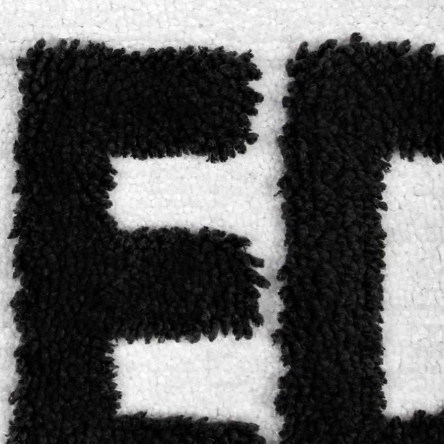 Raised pile, tufted slogan.