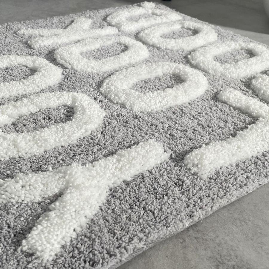hand tufted plush slogan bath mat