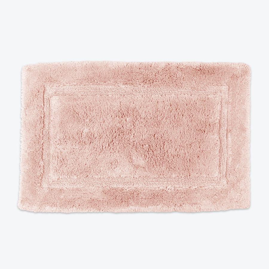Blush pink bamboo bath mats.