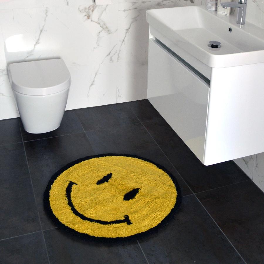 Smiley face bathroom mat. Yellow accent rug in round shape, fun statement mat for the bathroom or hallway.