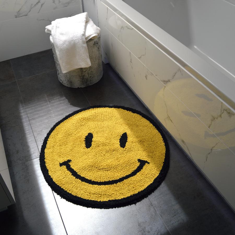Smiley face emoji bath mat. Yellow happy fun rug, statement round shape.