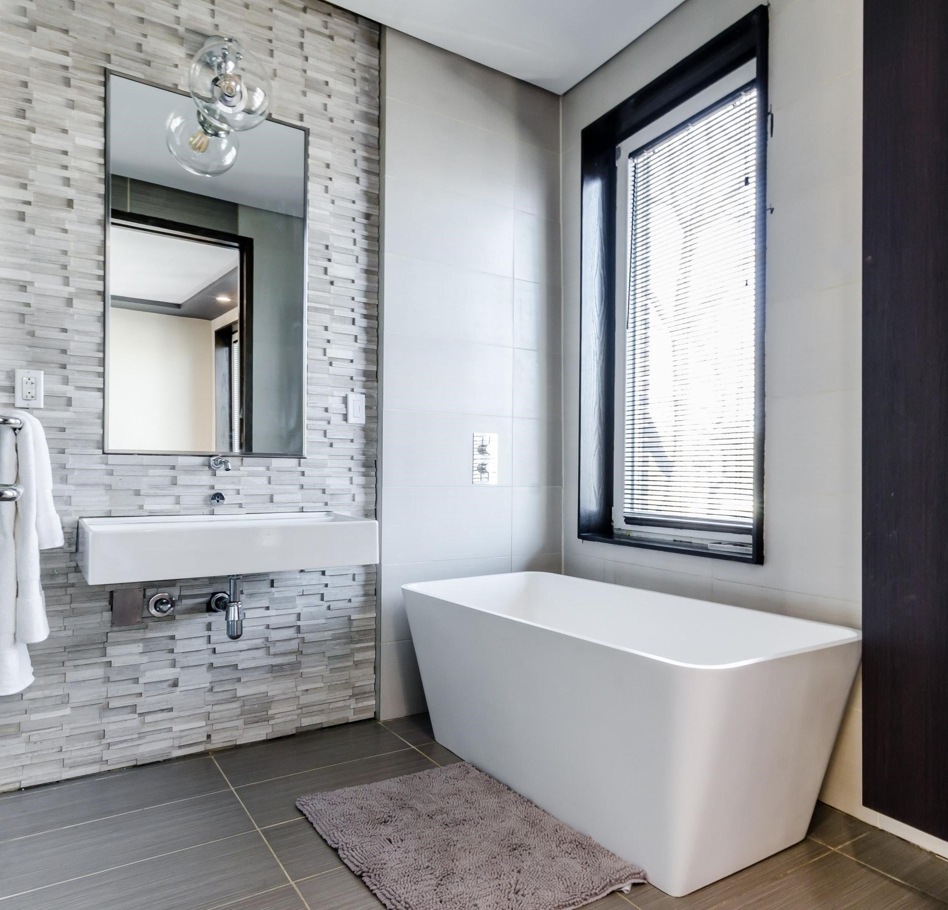 a modern bathroom with tiling and a large window