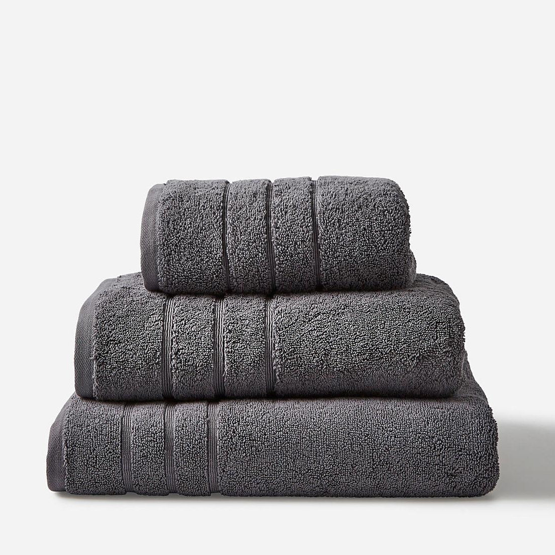 A stack of grey towels in mixed sizes.