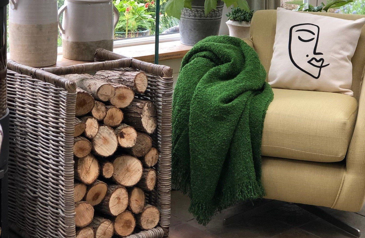 green mohair throw on yellow chair next to log pile