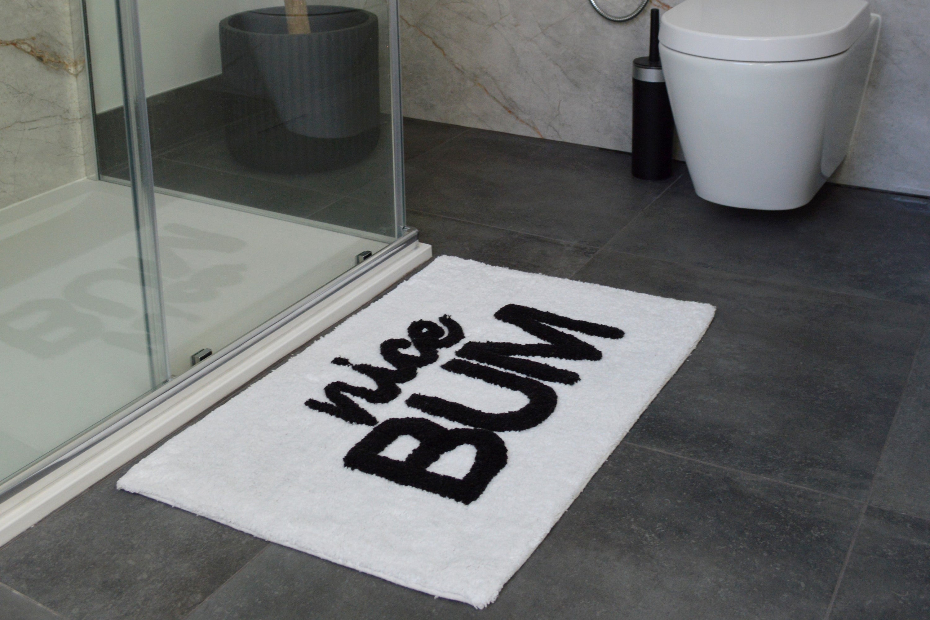 yellow bath mat with a smile