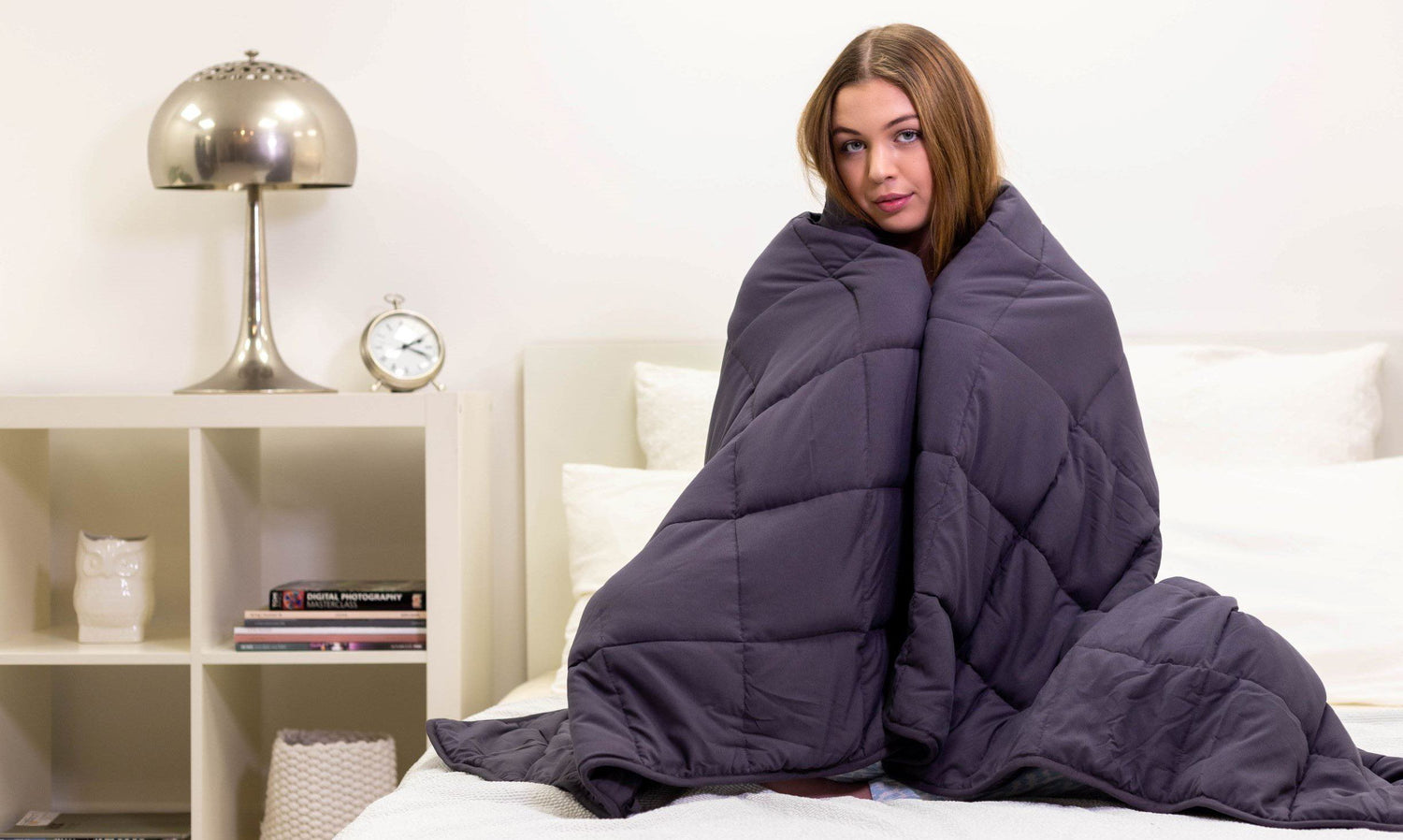 a lady feeling the weighted blanket benefits