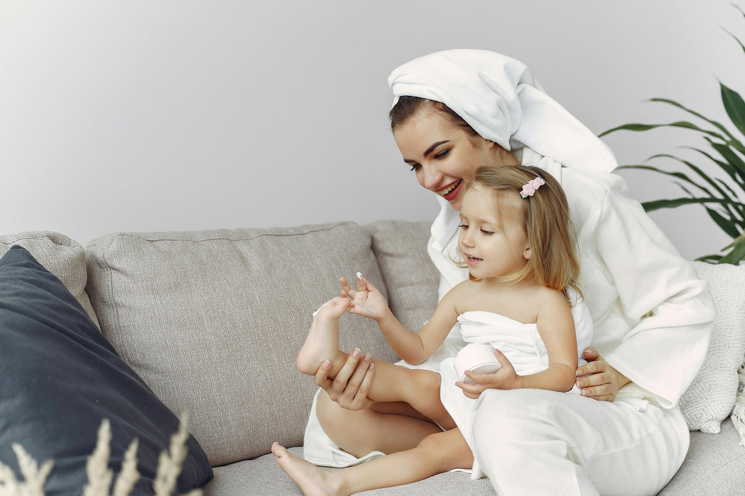 Mother and child in dressing gown and towels.