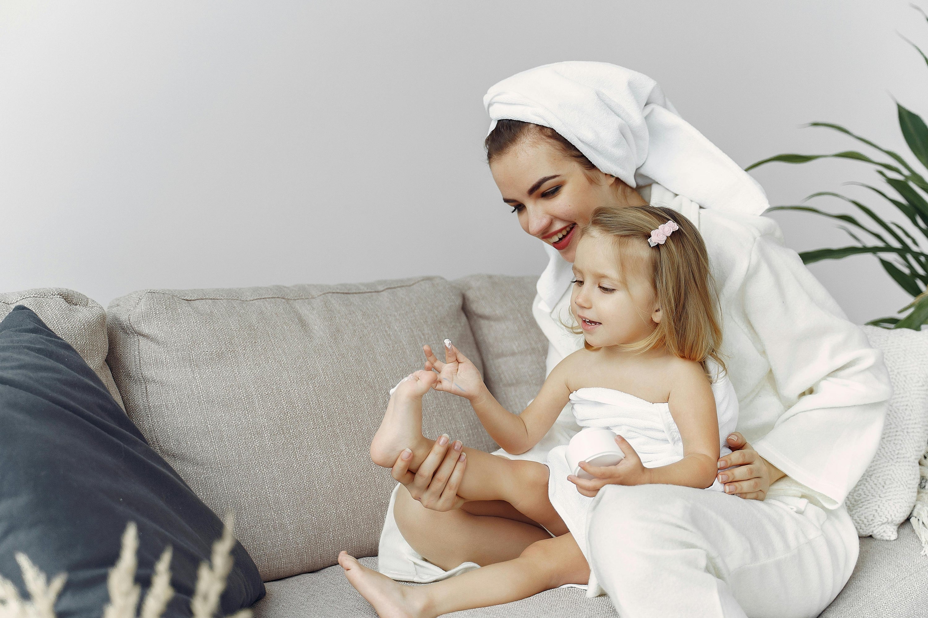 Mother and child in dressing gown and towels.