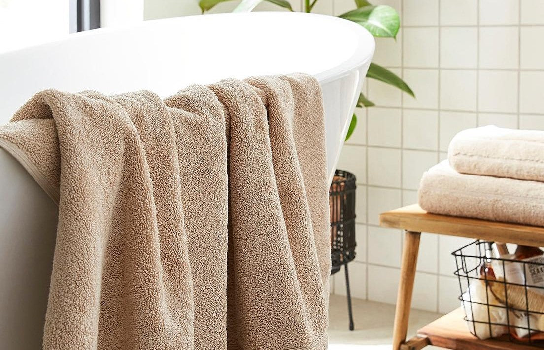 Neutral beige bathroom towels - brown bath towels, hand towels, and bath sheets.