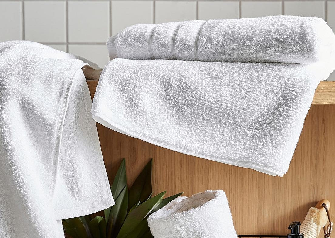 White towels for the bathroom. White hand towels, bath towels and bath sheets.