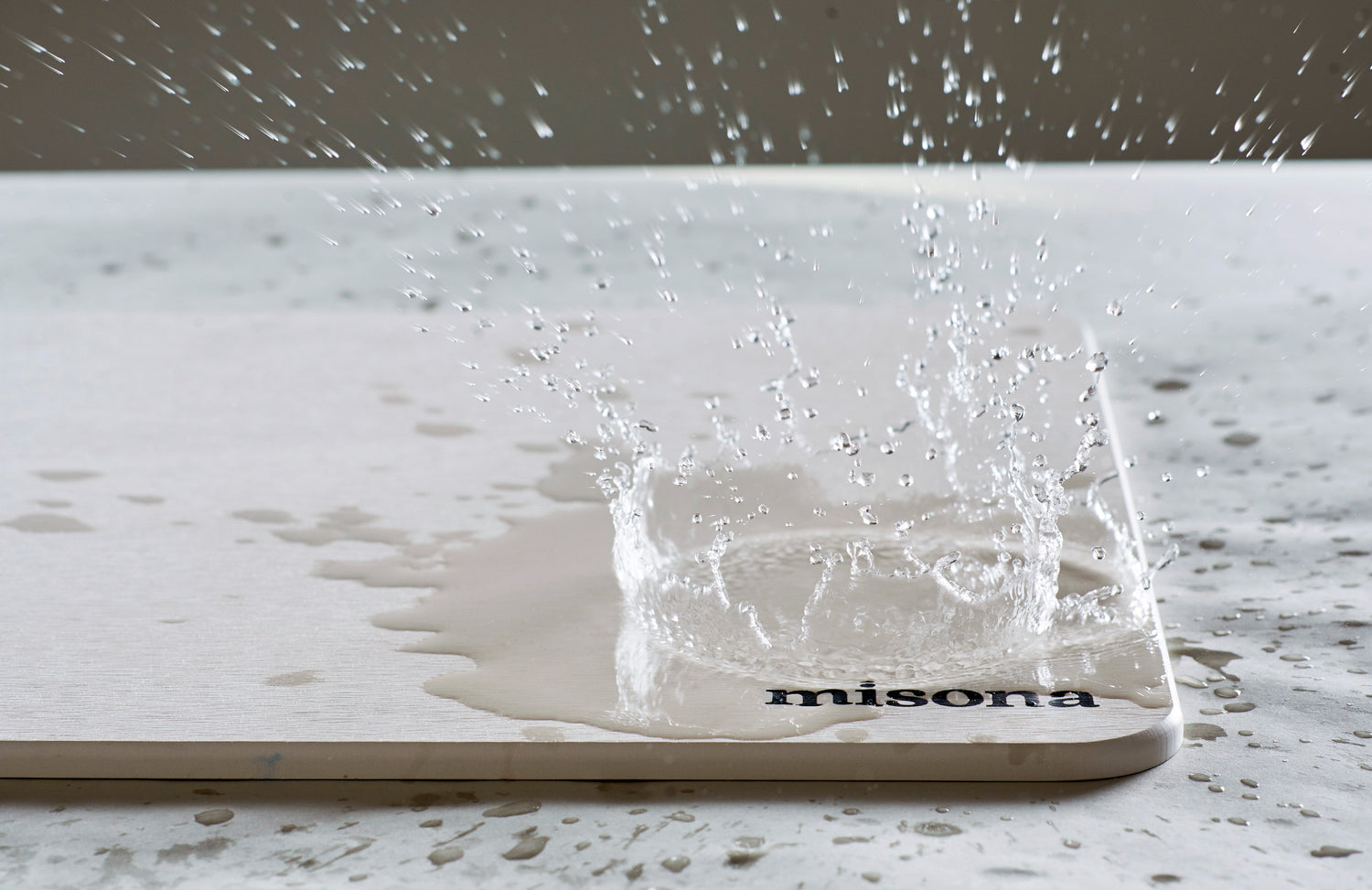 water splashing on a diatomite stone bath mat