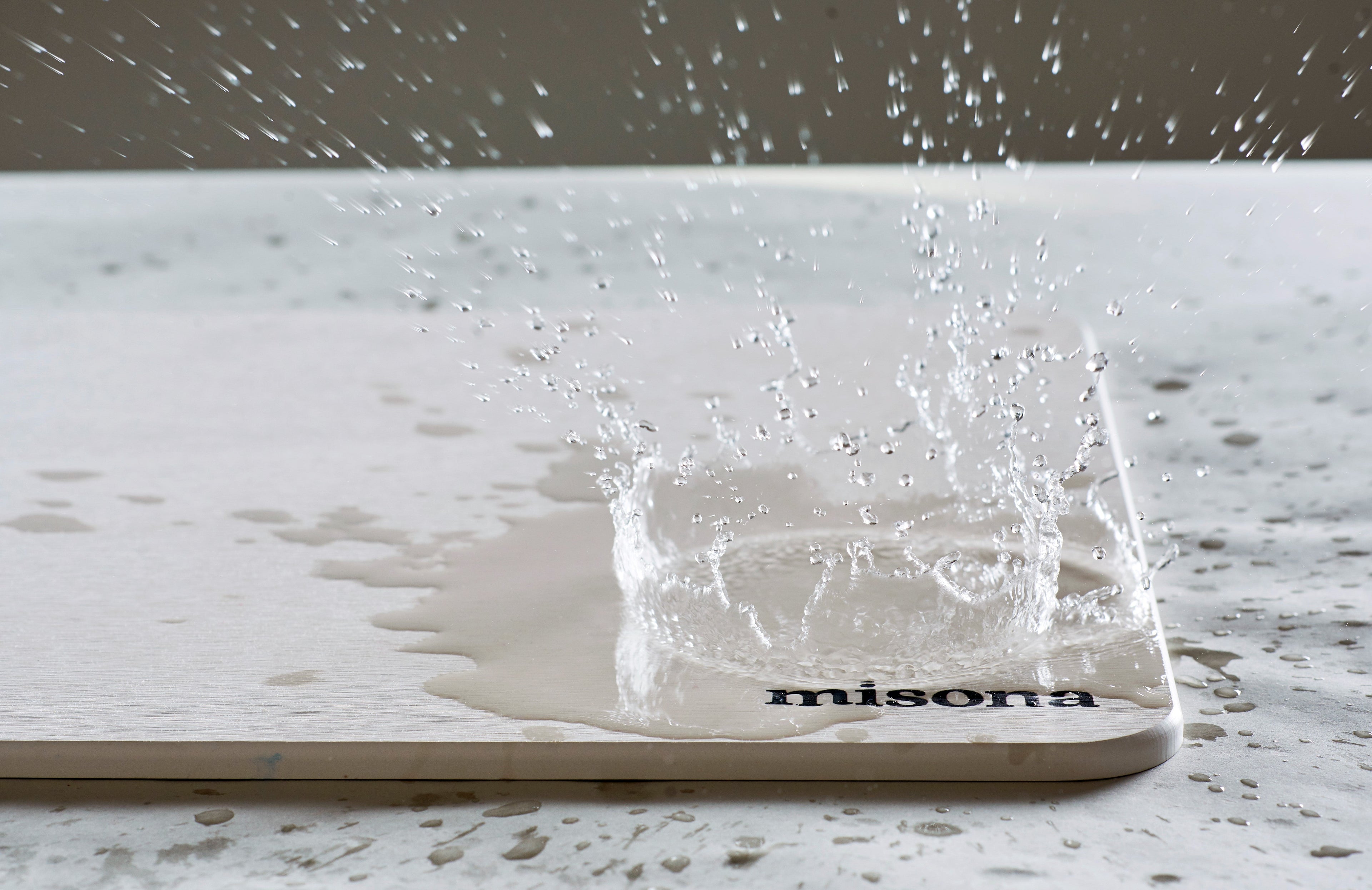 water splashing on a diatomite stone bath mat