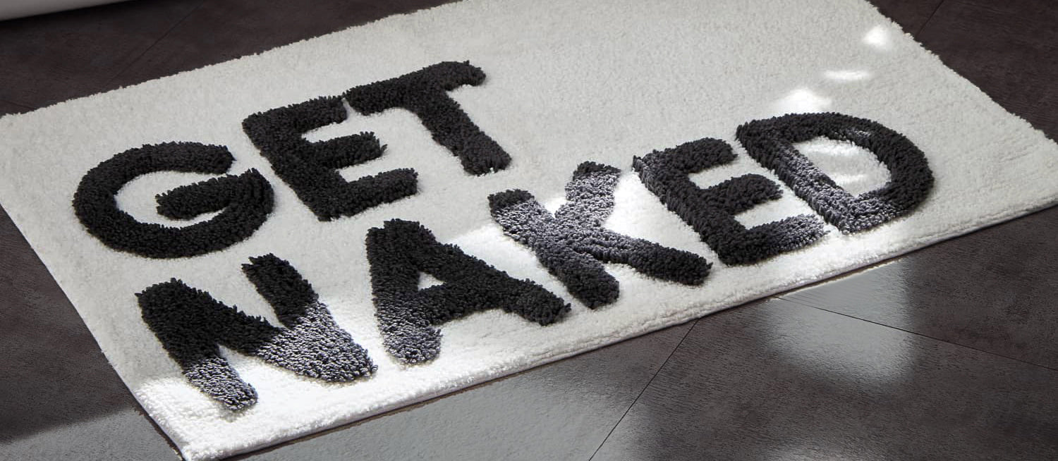 Get naked slogan bath mats, fun hand tufted rugs for the bathroom and home.