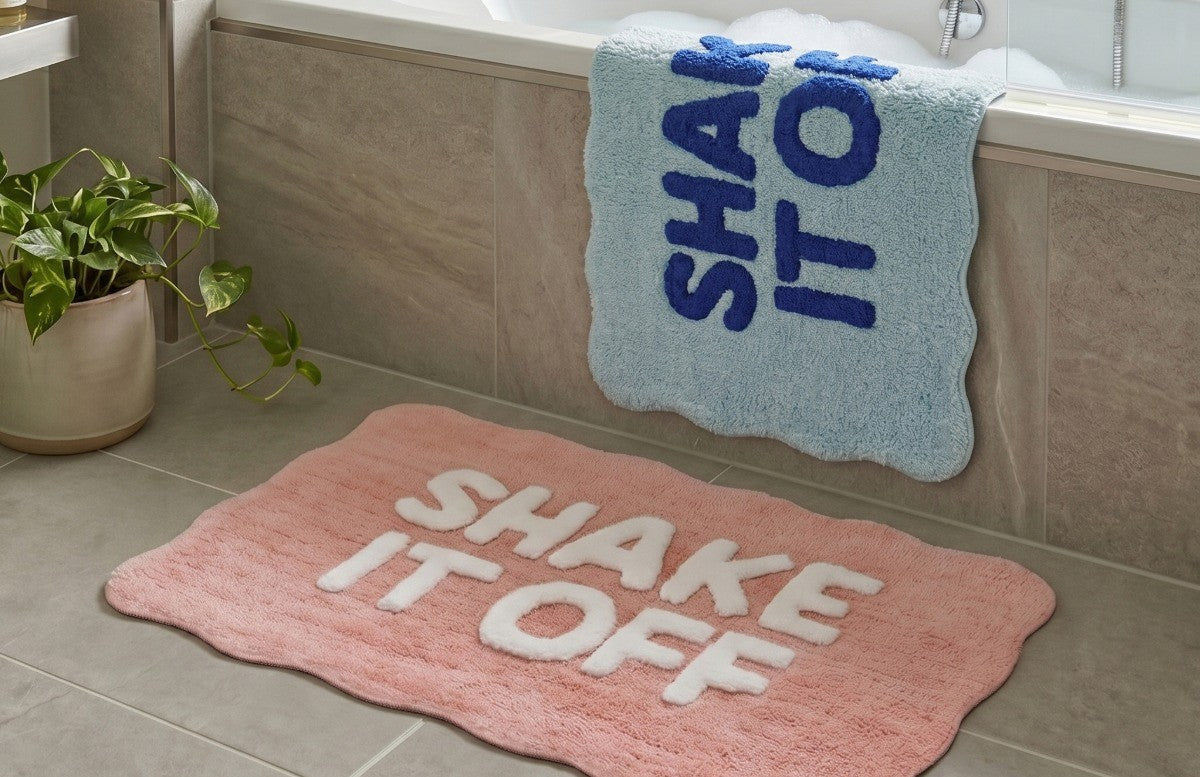 Scalloped bath mat with shake it off slogan