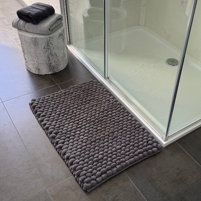 Grey textured bobble bath mat with thick deep pile. 