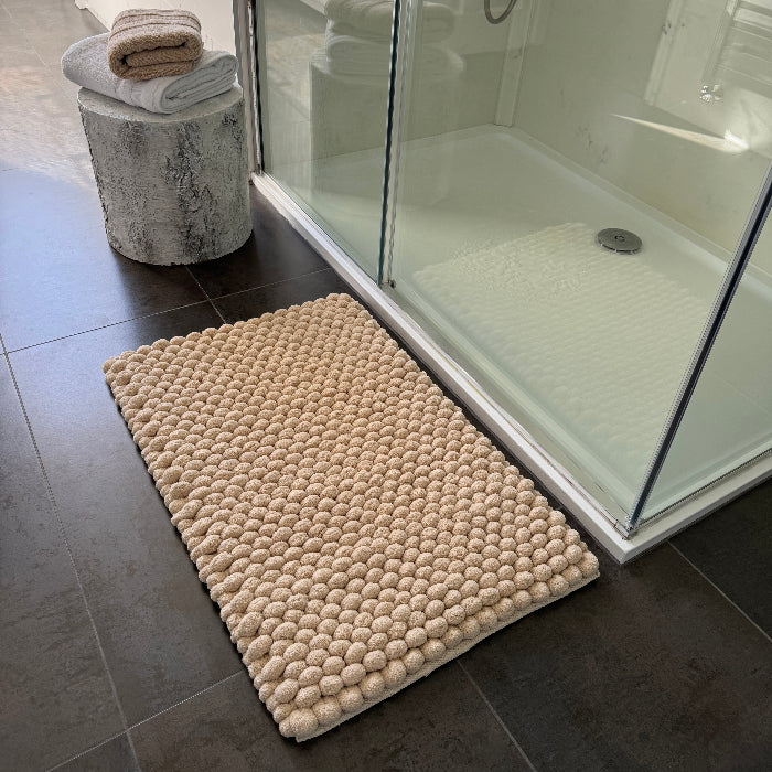 Beige textured bobble bath mat in super thick and luxurious style.