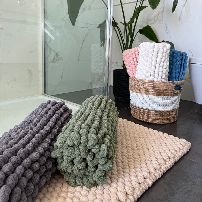 Collection of thick bath mats with giant textured bobbles - variety of colours.