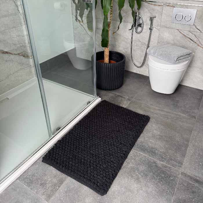 Thick bobble black bath mat with non slip backing.