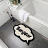 Black and white Bonjour slogan bath mat.