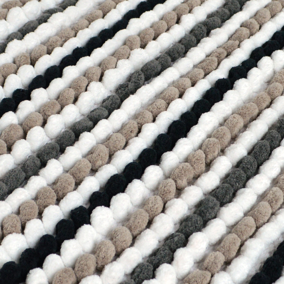 close up of a chunky bobble bath mat in monochrome