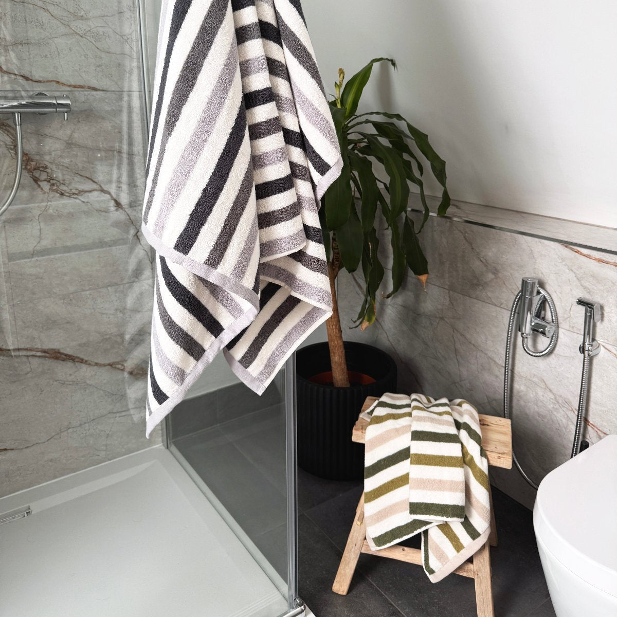 Patterned stripe towels, available in green and grey colours.