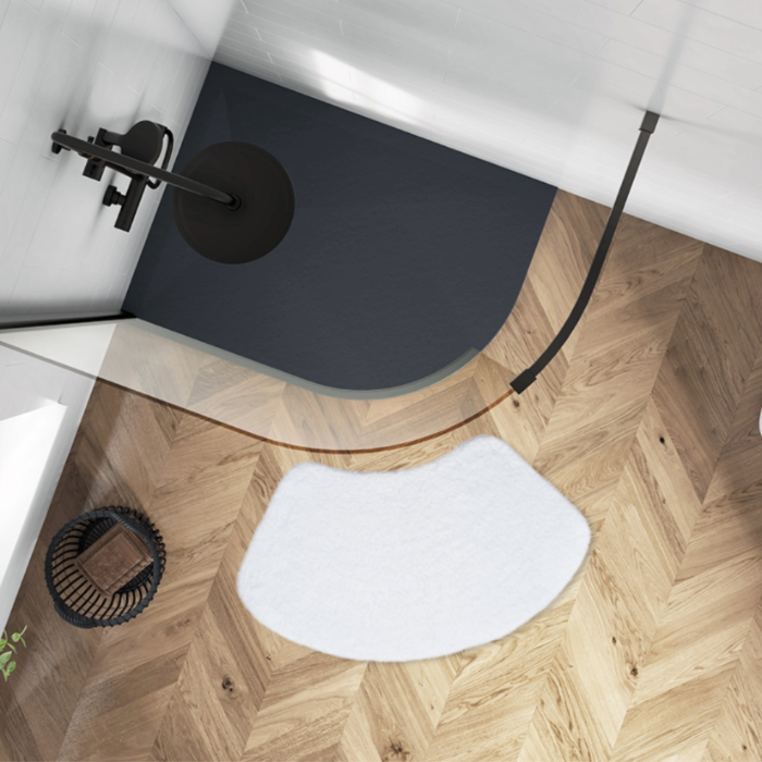 Curved white bath mat for shower unit.