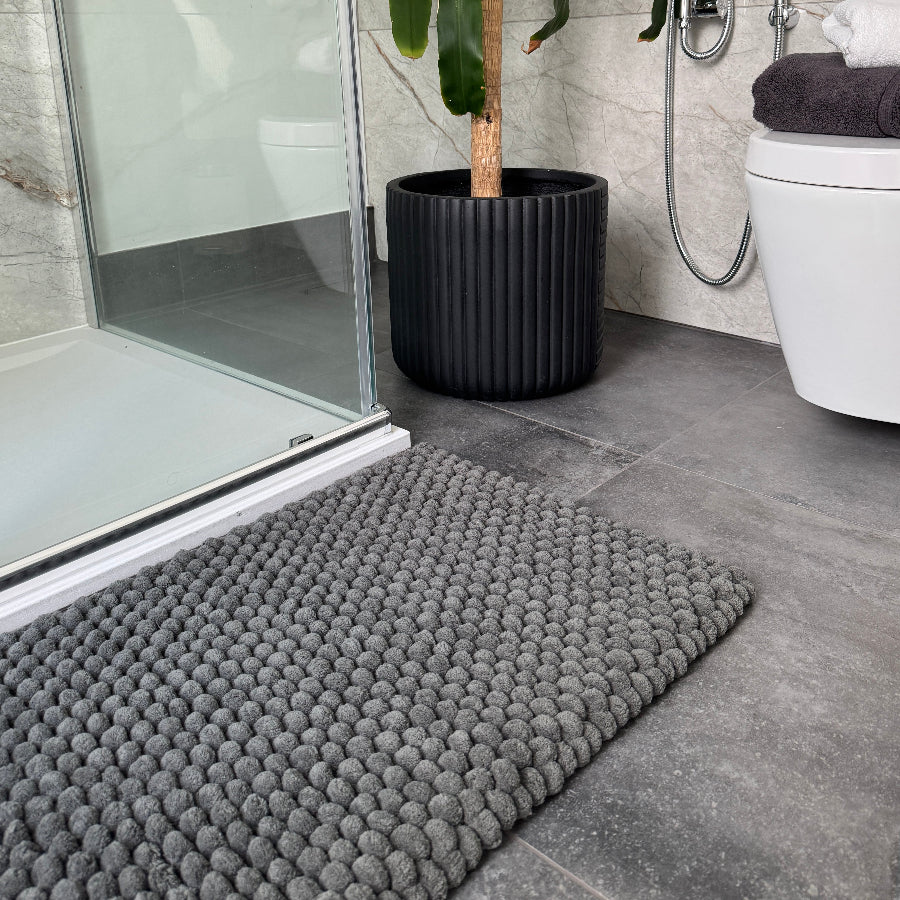 Grey thick bath mats for the bathroom or en suite with chunky textured bobbles.