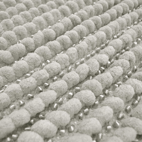 Light grey toilet mat in thick chunky bobble style.