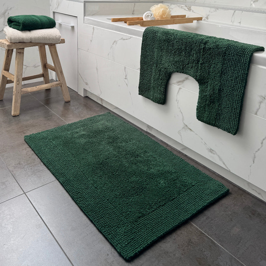 Dark green pedestal mat and bath mat for the bathroom. Co-ordinated bath mat set made from cotton.