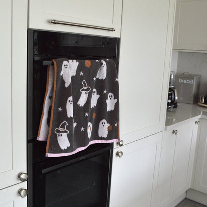 Cute ghost Halloween towels in grey and pink. Kitchen tea towels for fall decor.