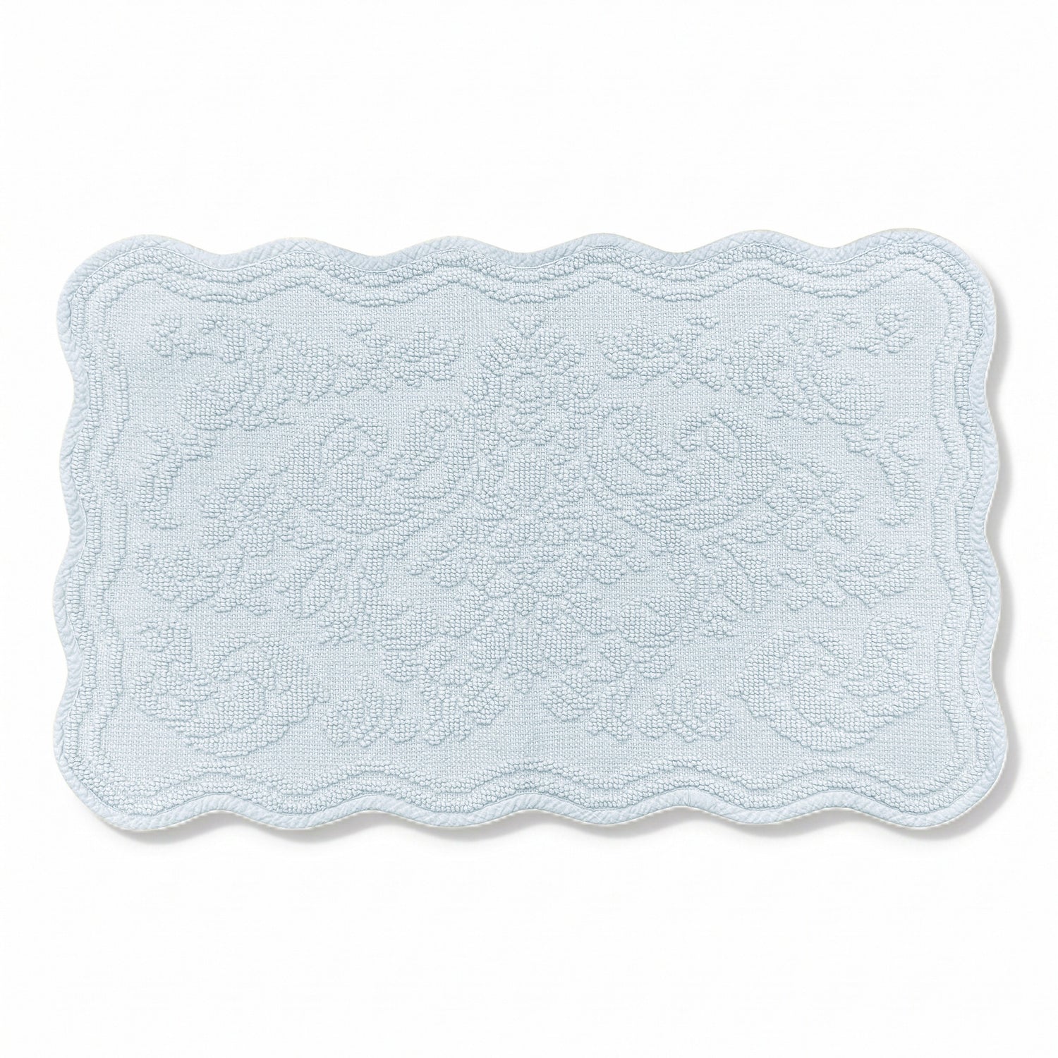 Scalloped bath mat in baby blue colour, with floral texture design - made from 100% cotton.