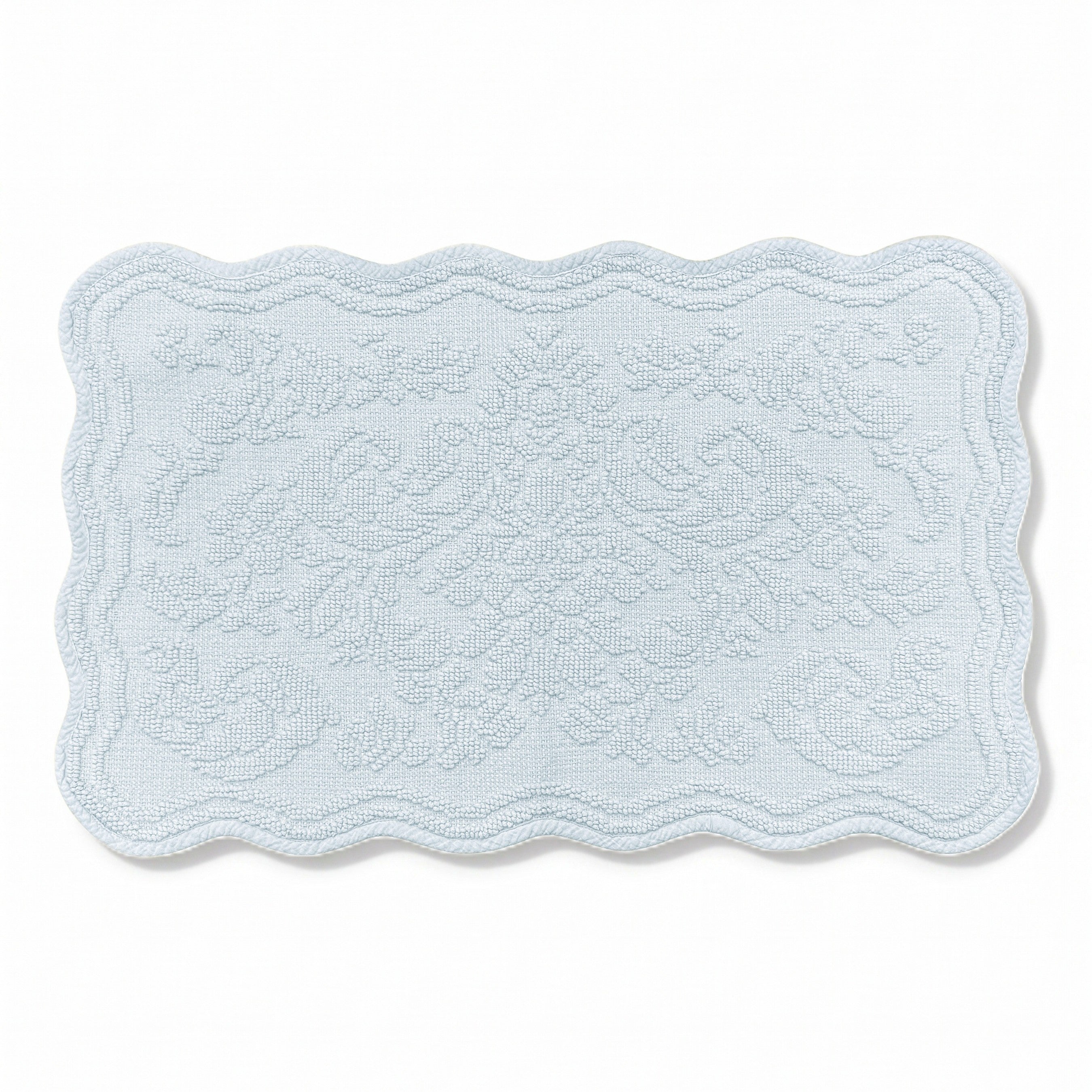 Scalloped bath mat in baby blue colour, with floral texture design - made from 100% cotton.