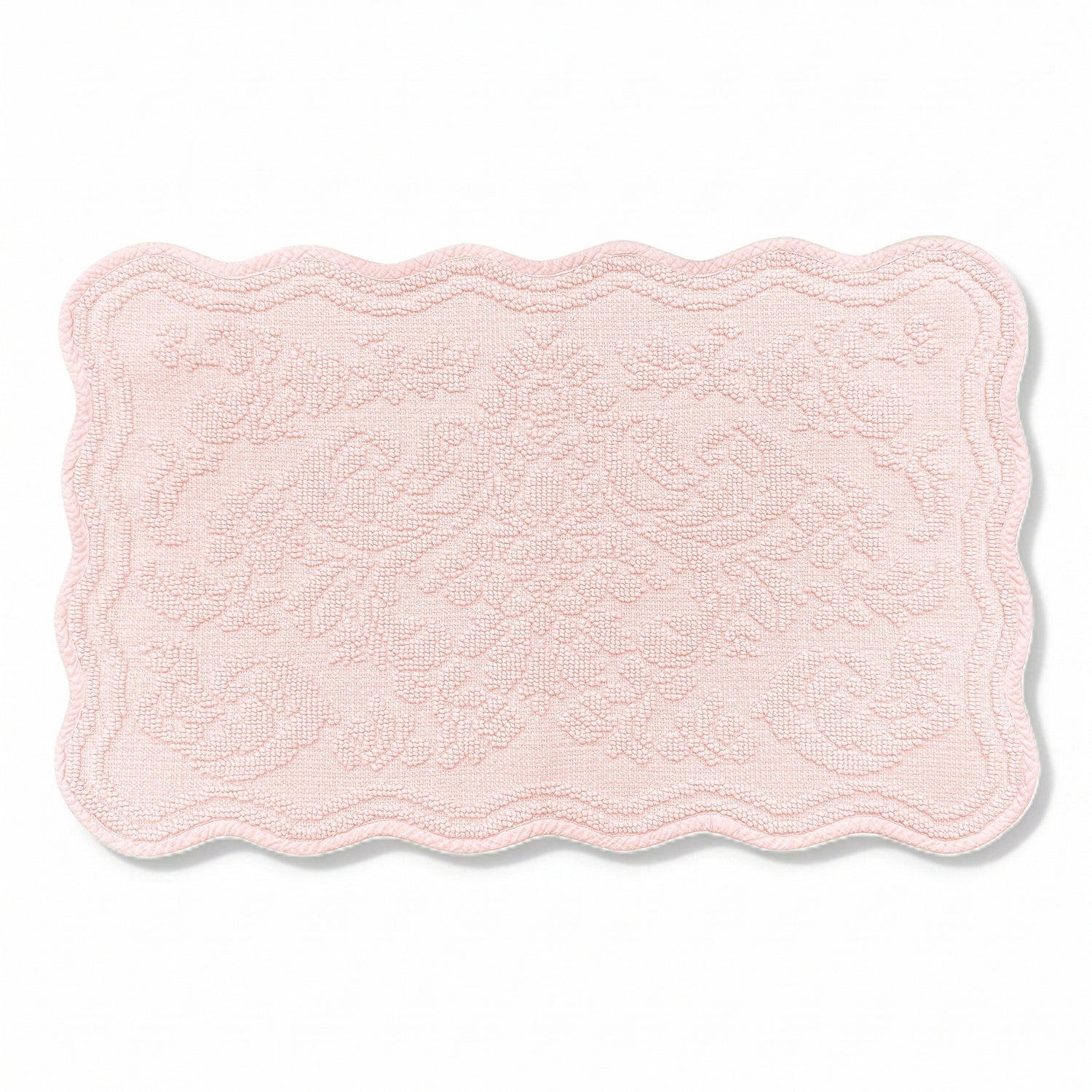Scalloped bath mat in blush pink colour, with floral texture design - made from 100% cotton.