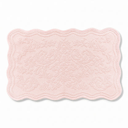 Scalloped bath mat in blush pink colour, with floral texture design - made from 100% cotton.