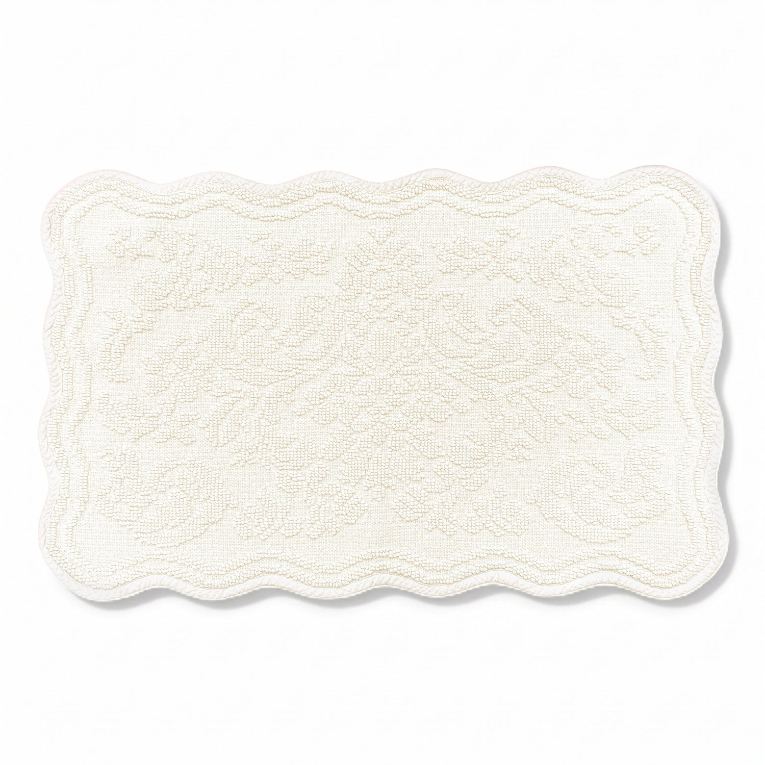 Scalloped bath mat in cream colour, with floral texture design - made from 100% cotton.