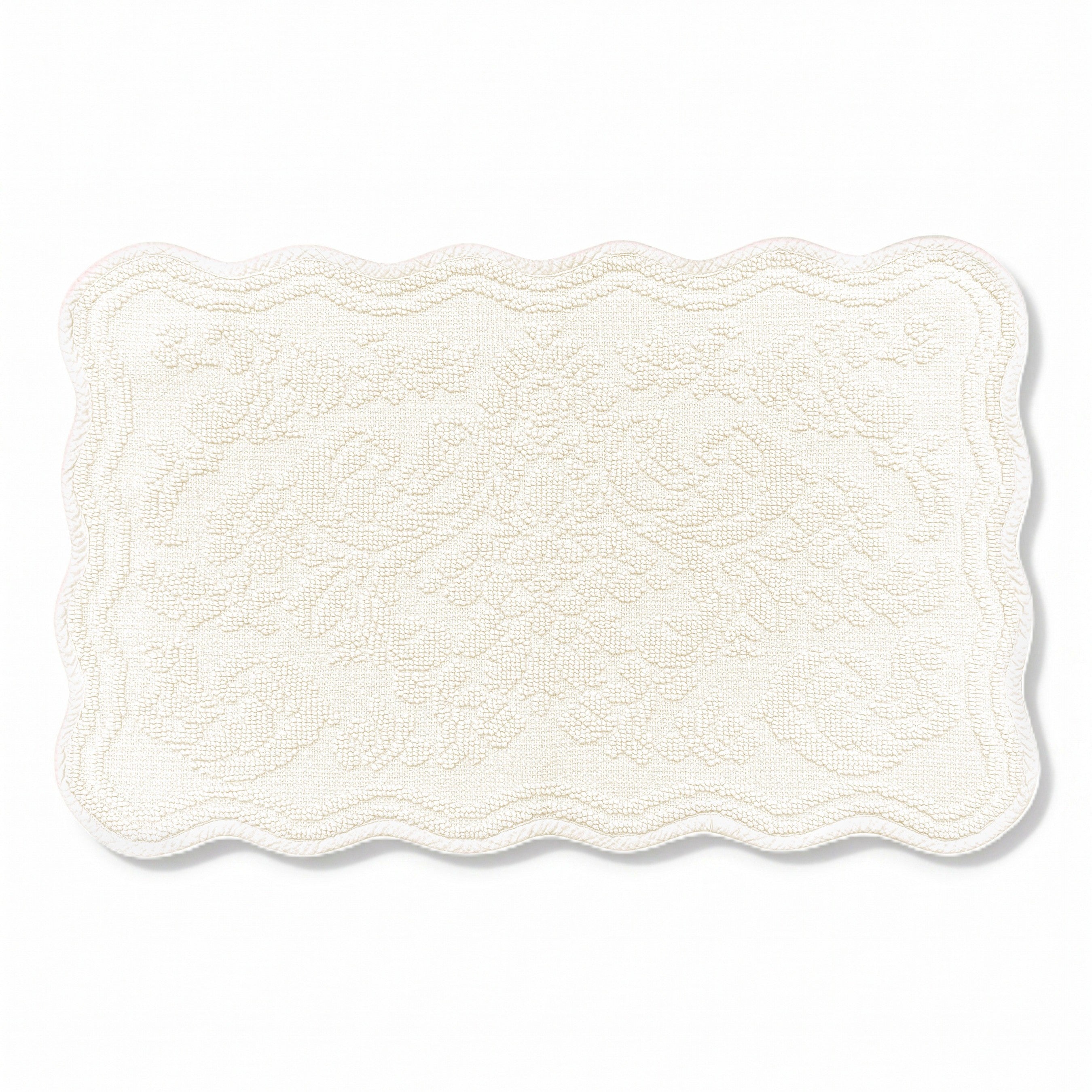 Scalloped bath mat in cream colour, with floral texture design - made from 100% cotton.