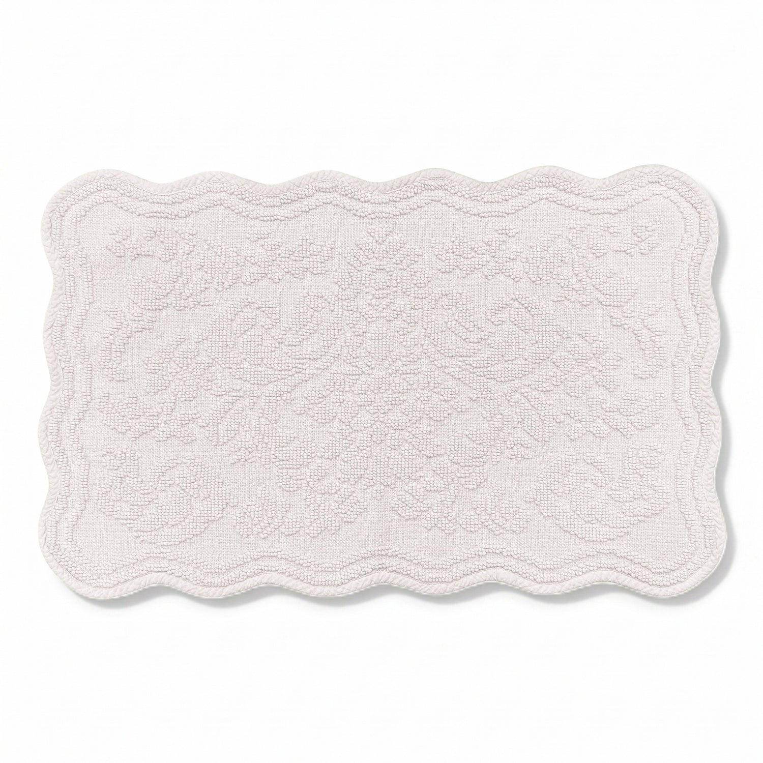 Scalloped bath mat in light grey colour, with floral texture design - made from 100% cotton.