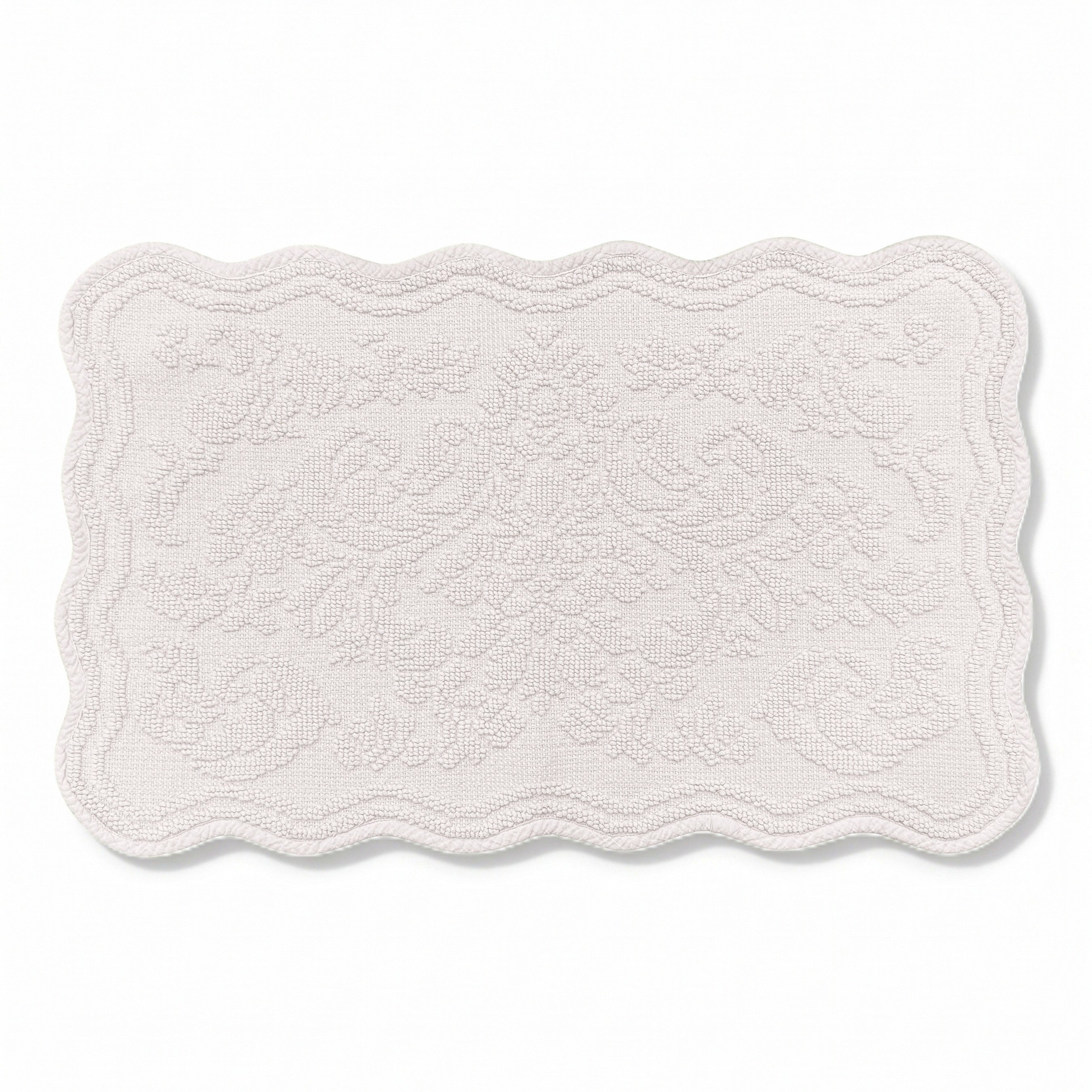 Scalloped bath mat in light grey colour, with floral texture design - made from 100% cotton.